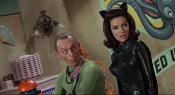 Movie still from “Batman: The Movie” (1966), directed by Leslie H. Martinson – A man and a woman dressed as batman and catwoman; Medium shot, Low angle