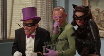 Movie still from “Batman: The Movie” (1966), directed by Leslie H. Martinson – A group of men and women dressed as batman and the riddler; Medium shot, Low angle