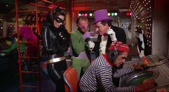 Movie still from “Batman: The Movie” (1966), directed by Leslie H. Martinson – A group of people dressed up as batman and the riddler; Medium shot, High angle