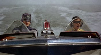 Movie still from “Batman: The Movie” (1966), directed by Leslie H. Martinson – Two people in a boat in the water; Medium shot, Low angle