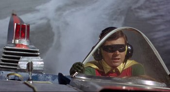 Movie still from “Batman: The Movie” (1966), directed by Leslie H. Martinson – A person in a car in the water; Medium shot, Low angle