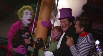 Movie still from “Batman: The Movie” (1966), directed by Leslie H. Martinson – A group of people dressed as joker and the riddler; Medium shot, Low angle