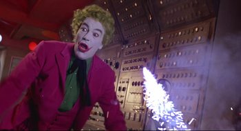 Movie still from “Batman: The Movie” (1966), directed by Leslie H. Martinson – A man dressed as the joker in front of an electrical panel; Medium shot, Low angle