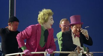 Movie still from “Batman: The Movie” (1966), directed by Leslie H. Martinson – A group of people in costumes on a stage; Medium shot, High angle