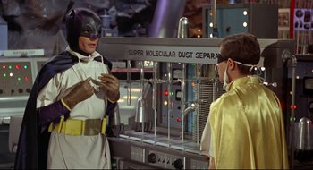 Movie still from “Batman: The Movie” (1966), directed by Leslie H. Martinson – Two men in costumes stand in front of a machine; Medium shot, Low angle