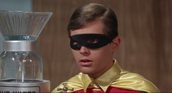 Movie still from “Batman: The Movie” (1966), directed by Leslie H. Martinson – A young man wearing a yellow and red costume; Close Up shot, Low angle