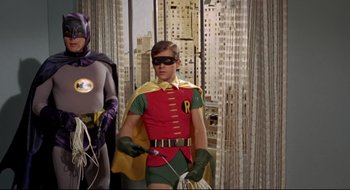 Movie still from “Batman: The Movie” (1966), directed by Leslie H. Martinson – A man dressed as batman and robin in costume; Medium shot, Low angle