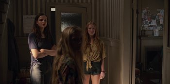 Movie still from “Dark” (2017), created by Baran bo Odar – A group of young women standing in a room; Medium shot, Low angle