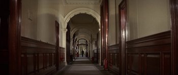 Movie still from “The Battle of Britain” (1969), directed by Guy Hamilton – A long hallway with a person walking on the far side of it; Extreme Wide shot, High angle