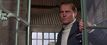 Movie still from “The Battle of Britain” (1969), directed by Guy Hamilton – A person wearing a suit and tie; Close Up shot, Low angle