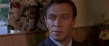 Movie still from “The Battle of Britain” (1969), directed by Guy Hamilton – A person wearing a suit and tie; Close Up shot, Low angle
