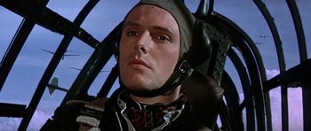 Movie still from “The Battle of Britain” (1969), directed by Guy Hamilton – A person wearing a helmet; Close Up shot, Low angle