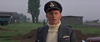 Movie still from “The Battle of Britain” (1969), directed by Guy Hamilton – A man wearing a uniform and a hat; Close Up shot, Low angle