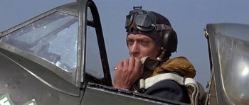 Movie still from “The Battle of Britain” (1969), directed by Guy Hamilton – An older man in an old fighter plane; Close Up shot, Low angle