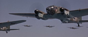 Movie still from “The Battle of Britain” (1969), directed by Guy Hamilton – A group of planes flying in the sky; Wide shot, Low angle