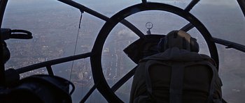 Movie still from “The Battle of Britain” (1969), directed by Guy Hamilton – A view of a city from a plane window; Wide shot, High angle