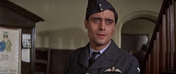 Movie still from “The Battle of Britain” (1969), directed by Guy Hamilton – A person wearing a uniform and wearing a hat; Close Up shot, Low angle