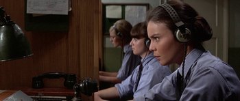 Movie still from “The Battle of Britain” (1969), directed by Guy Hamilton – A group of people sitting in a room; Close Up shot, High angle