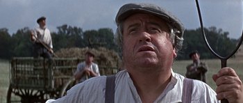 Movie still from “The Battle of Britain” (1969), directed by Guy Hamilton – An older man wearing a hat and a striped shirt; Close Up shot, Low angle