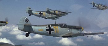 Movie still from “The Battle of Britain” (1969), directed by Guy Hamilton – Two planes flying in the air with clouds in the background; Wide shot, Overhead angle