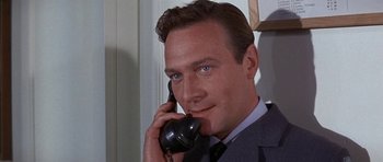 Movie still from “The Battle of Britain” (1969), directed by Guy Hamilton – A person talking on a phone; Close Up shot, Low angle