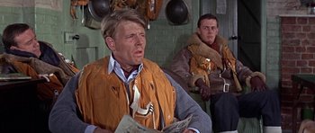 Movie still from “The Battle of Britain” (1969), directed by Guy Hamilton – Two men sitting next to each other in a room; Medium shot, Over the shoulder angle