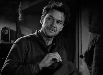 Movie still from “Battleground” (1949), directed by William A. Wellman – Black and white photograph of a man in a sweater; Close Up shot, Low angle