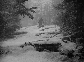 Movie still from “Battleground” (1949), directed by William A. Wellman – A person walking through the snow on a path; Extreme Wide shot, High angle