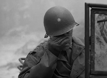 Movie still from “Battleground” (1949), directed by William A. Wellman – An old photo of a man in a military uniform; Close Up shot, Over the shoulder angle
