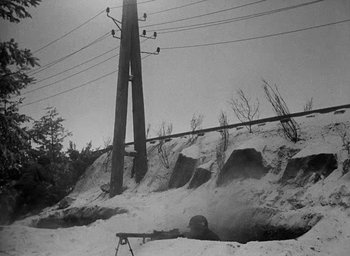 Movie still from “Battleground” (1949), directed by William A. Wellman – An old photo of a soldier in the snow; Wide shot, High angle