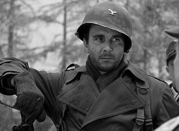 Movie still from “Battleground” (1949), directed by William A. Wellman – A man in a military uniform and a helmet; Close Up shot, Low angle