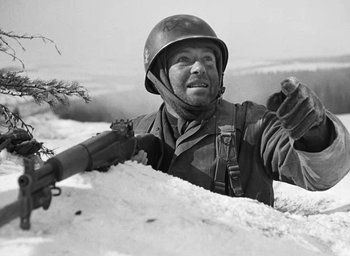 Movie still from “Battleground” (1949), directed by William A. Wellman – An old photo of a soldier in the snow; Medium shot, Low angle