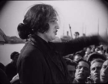 Movie still from “Battleship Potemkin” (1925), directed by Sergei Eisenstein – An old photo of a woman standing in front of a crowd; Medium shot, Low angle
