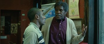 Movie still from “Be Kind Rewind” (2008), directed by Michel Gondry – Two men are standing next to each other in a room; Medium shot, Over the shoulder angle