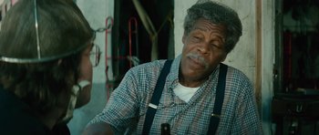 Movie still from “Be Kind Rewind” (2008), directed by Michel Gondry – An older man wearing a plaid shirt and suspenders; Close Up shot, Over the shoulder angle
