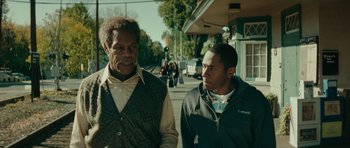 Movie still from “Be Kind Rewind” (2008), directed by Michel Gondry – Two men walking down the street talking to each other; Close Up shot, Over the shoulder angle