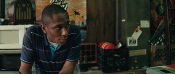 Movie still from “Be Kind Rewind” (2008), directed by Michel Gondry – A man sitting at a table in front of a basket; Close Up shot, Over the shoulder angle