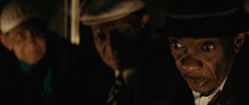 Movie still from “Be Kind Rewind” (2008), directed by Michel Gondry – A man and a woman wearing hats and suits; Close Up shot, Over the shoulder angle