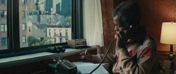 Movie still from “Be Kind Rewind” (2008), directed by Michel Gondry – An older man sitting in front of a window talking on the phone; Medium shot, High angle
