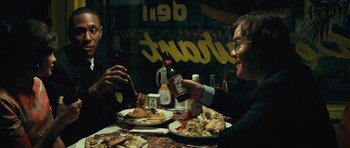 Movie still from “Be Kind Rewind” (2008), directed by Michel Gondry – Two people sitting at a table with plates of food and drinks; Medium shot, Over the shoulder angle