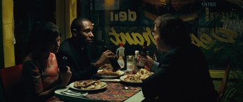 Movie still from “Be Kind Rewind” (2008), directed by Michel Gondry – Two men sitting at a table with plates of food in front of them; Medium shot, Over the shoulder angle