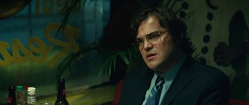 Movie still from “Be Kind Rewind” (2008), directed by Michel Gondry – A man in a suit and tie sitting in a chair; Close Up shot, Low angle