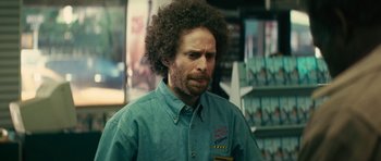 Movie still from “Be Kind Rewind” (2008), directed by Michel Gondry – A man in a green shirt is standing in a store; Close Up shot, Over the shoulder angle