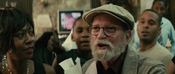 Movie still from “Be Kind Rewind” (2008), directed by Michel Gondry – An old man with a beard and glasses and a hat; Close Up shot, Over the shoulder angle