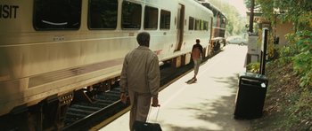 Movie still from “Be Kind Rewind” (2008), directed by Michel Gondry – A man walking down a train platform with a suitcase; Wide shot, High angle