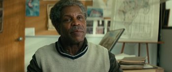 Movie still from “Be Kind Rewind” (2008), directed by Michel Gondry – An older man wearing a white sweater and a black and white shirt; Close Up shot, Over the shoulder angle