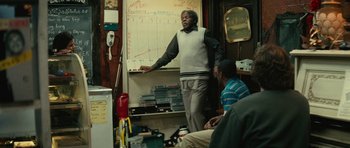 Movie still from “Be Kind Rewind” (2008), directed by Michel Gondry – A man standing in front of a white board; Medium shot, Over the shoulder angle