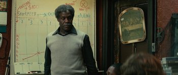 Movie still from “Be Kind Rewind” (2008), directed by Michel Gondry – A man standing in front of a mirror in a room; Medium shot, Over the shoulder angle