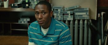 Movie still from “Be Kind Rewind” (2008), directed by Michel Gondry – A person sitting in front of boxes; Close Up shot, Low angle