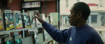 Movie still from “Be Kind Rewind” (2008), directed by Michel Gondry – A man is looking at a bunch of pictures; Close Up shot, Over the shoulder angle